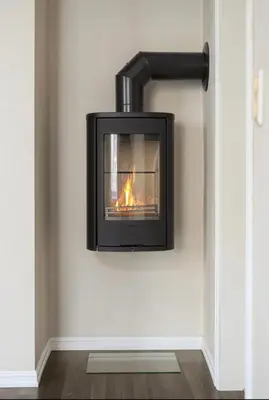 a fireplace on the wall in a room at Nouveau Nook in Ålesund