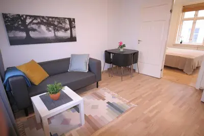 a living room with a couch and a table at Super cozy 3-bedroom in picturesque neigborhood in Bergen