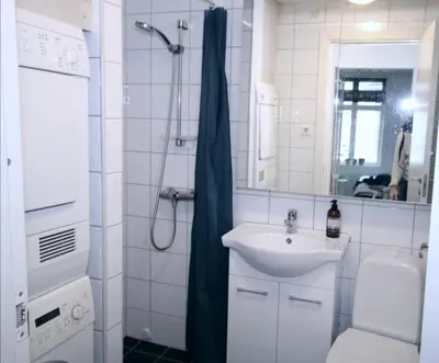 a bathroom with a sink and a shower at Super cozy 3-bedroom in picturesque neigborhood in Bergen