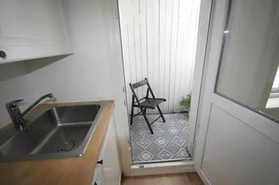 a kitchen with a sink and a chair in a room at Super cozy 3-bedroom in picturesque neigborhood in Bergen