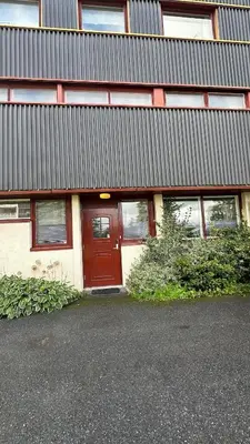 a building with a red door in front of it at One bedroom apartment close to Asker centrum in Lii