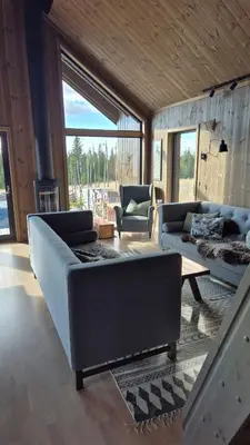 a living room with two couches and a table at Cabin Lillehammer, Nordseter, Sjusjøen in Lillehammer