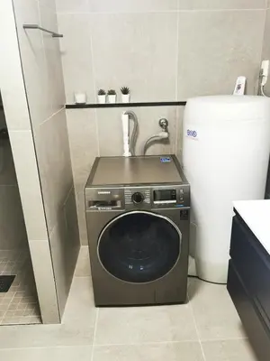 a washing machine in a bathroom next to a toilet at Cozy apartment close to many experiences in Segalstad