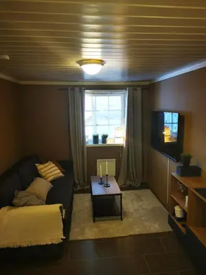 a living room with a couch and a table at Cozy apartment close to many experiences in Segalstad