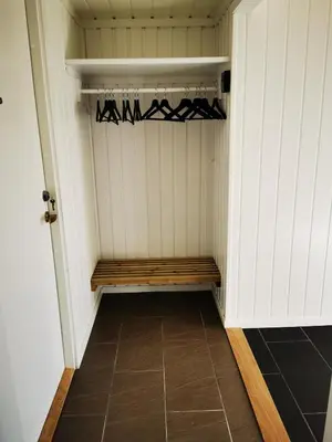 a room with a closet with a bench in it at Cozy apartment close to many experiences in Segalstad