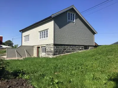 a house on top of a grassy hill at Gamlemgarden by Norgesbooking - house by the sea in Longva