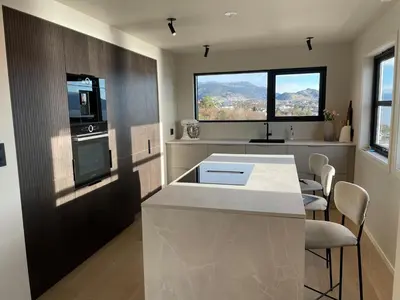a kitchen with a counter and a stove top oven at Large villa with boathouse in Lunde
