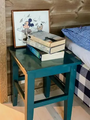 a blue table with books on it next to a bed at Modern Cabin With Breathtaking View At Norefjell in Eggedal