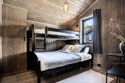 a bedroom with two bunk beds in a cabin at New, cozy cottage on Norefjell with stunning views in Noresund