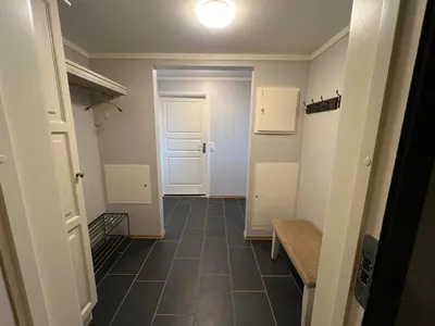 a hallway with a door and a tiled floor at Appartment at Stølstunet in Beitostølen in Beitostøl