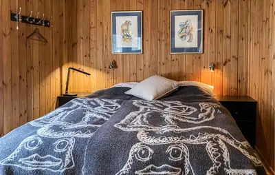 a bedroom with a bed with a patterned blanket on it at Gorgeous Home In Bjorli With Wifi in Bjorli