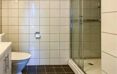 a bathroom with a toilet and a glass shower at Gorgeous Home In Bjorli With Wifi in Bjorli