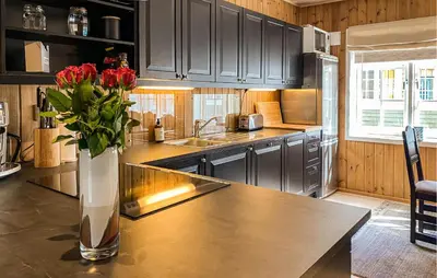 a kitchen with a vase of flowers on a table at Gorgeous Home In Bjorli With Wifi in Bjorli