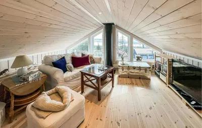 a living room with a large wooden ceiling at Beautiful Home In Sjusjøen With Wifi in Sjusjøen