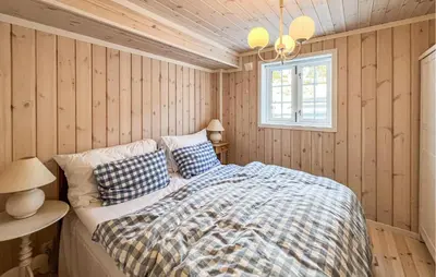 a bedroom with a bed and a window at Beautiful Home In Sjusjøen With Wifi in Sjusjøen