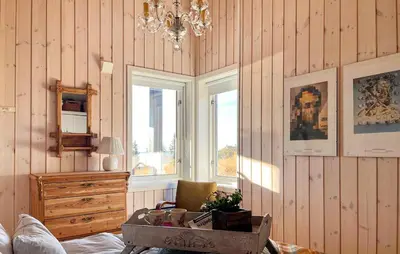 a room with wood paneled walls with a dresser and a window at Beautiful Home In Sjusjøen With Wifi in Sjusjøen