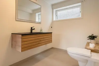 a bathroom with a sink and a toilet at Leilighet sentralt i Bud in Bud