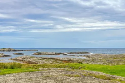 a view of the ocean with rocks and the water at Leilighet sentralt i Bud in Bud