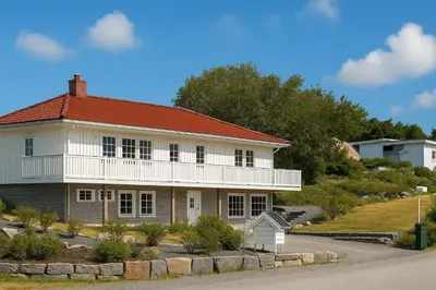 a large white house with a red roof at Leilighet sentralt i Bud in Bud