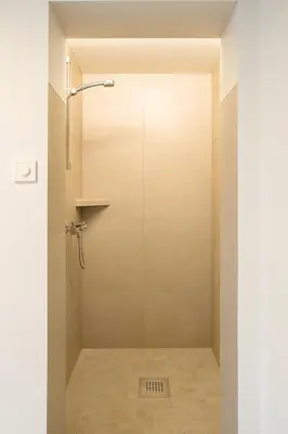 a shower with a glass door in a bathroom at Leilighet sentralt i Bud in Bud