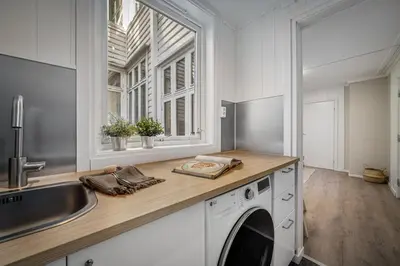 a kitchen with a sink and a washing machine at Bergen style Apt I Cozy street I Easy check in in Bergen