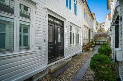 a walkway between two buildings with a black door at Bergen style Apt I Cozy street I Easy check in in Bergen