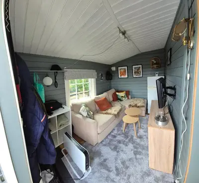 a living room with a couch and a table at Trysil Caravan Cycle in-out in Trysil
