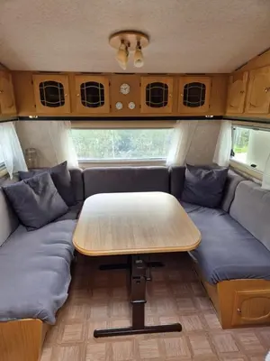 a table and couch in the back of a caravan at Trysil Caravan Cycle in-out in Trysil