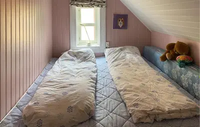 a bedroom with a bed with a teddy bear on it at Stunning Home In Runde With Wifi in Runde