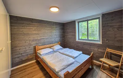 a bedroom with a bed and a window and a chair at Awesome Home In Sletta With Wifi in Sletta
