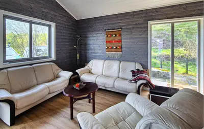 a living room with two couches and a table at Awesome Home In Sletta With Wifi in Sletta