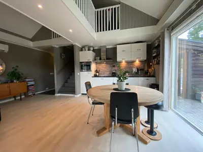 a kitchen and dining room with a wooden table and chairs at Cabin for rent in scenic Stryn in Stryn