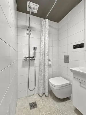 a white bathroom with a shower and a toilet at Fela Mirror Cabin Designer Hideaway 1000 m Above Sea Level in Aurdal