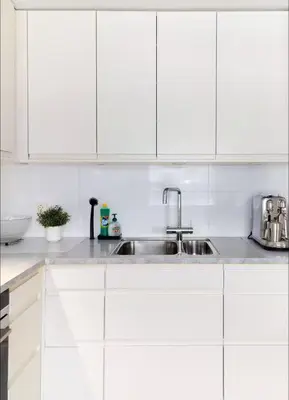 a kitchen with white cabinets and a sink at 2 bedroom, lake view, light rail, Bergen in Bergen