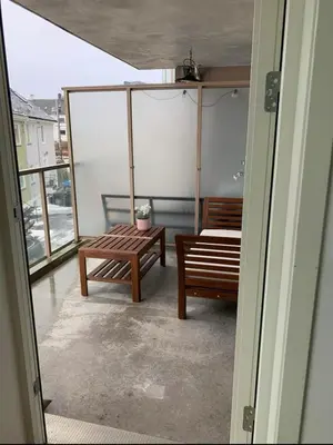 a balcony with two benches and a table at 2 bedroom, lake view, light rail, Bergen in Bergen