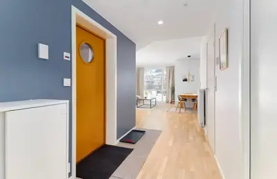 a hallway with a yellow door and a dining room at 2 bedroom, lake view, light rail, Bergen in Bergen
