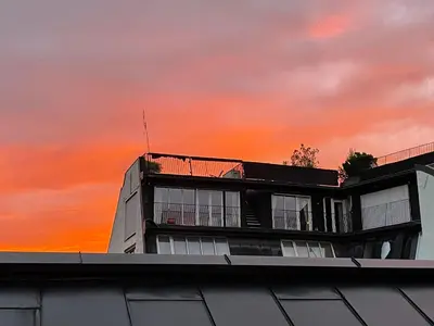 a building with a sunset in the background at oslo in Lii