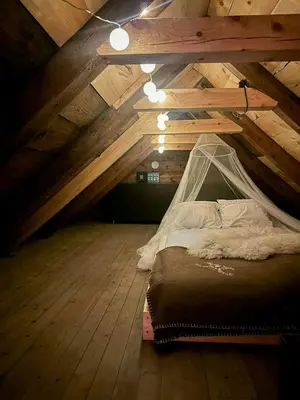 a bedroom with a bed in a attic at Historic Farm With Sea View Over Bjørnefjorden