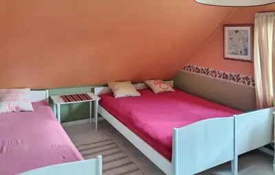two beds in a small room with pink sheets at Beautiful Home In Urangsvåg in Rolvsnes