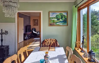 a dining room with a table and a window at Beautiful Home In Urangsvåg in Rolvsnes