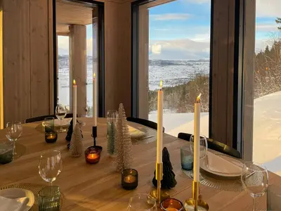 a dining room table with candles and wine glasses at Family Cabin With Picturesque View At Røn in Ron