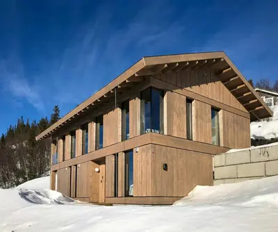 a wooden building in the snow with snow at Family Cabin With Picturesque View At Røn in Ron