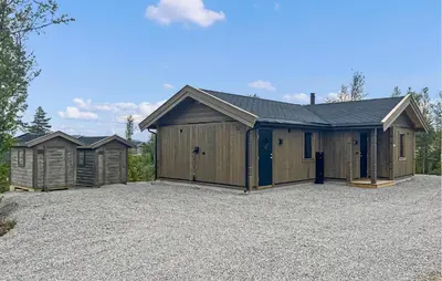 a row of buildings in a parking lot at 2 Bedroom Awesome Home In Engerdal in Kvisla