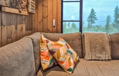 a couch with two pillows on it in a living room at 2 Bedroom Awesome Home In Engerdal in Kvisla