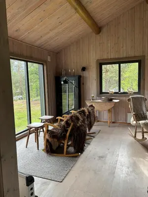 a living room with a couch and a table at Large and family friendly cabin near Langedrag in Tunhovd