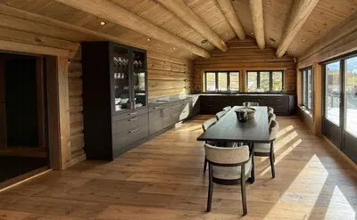 a dining room with a table and chairs at Luxurious Log Cabin At Mostertoppen in Øyer