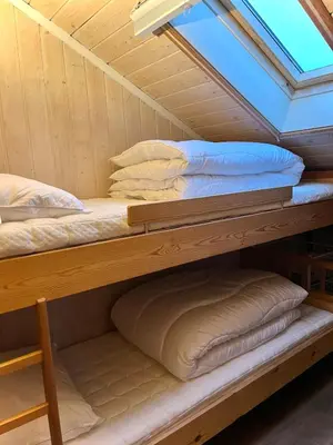 a bunk bed in a cabin with pillows at Modern cabin in amazing hiking area! in Gol