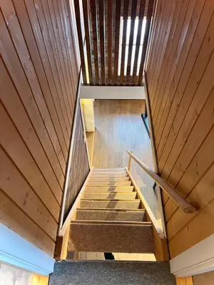 a staircase in a house with wooden ceilings at Modern cabin in amazing hiking area! in Gol