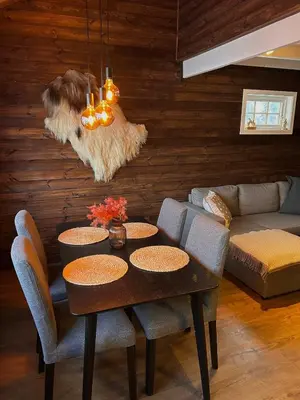 a living room with a table and chairs and a couch at Modern cabin in amazing hiking area! in Gol