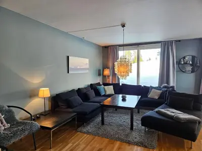a living room with a couch and a table at Kvitfjell mountain in Strande